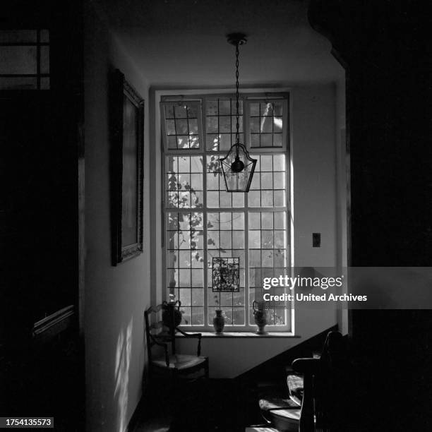 View into an old wooden staircase inside a house at Triberg in Black Forest, Germany 1930s.