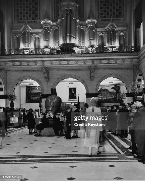 Shoppers enjoy a performance on the Wanamaker Grand Court Organ, the world's largest fully-functioning pipe organ in the Grand Court of Wanamaker's...