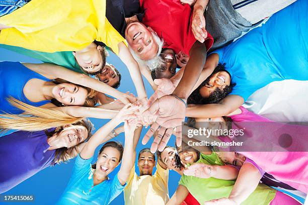 below view, circle of arms with hands in center - large group of people outside stock pictures, royalty-free photos & images