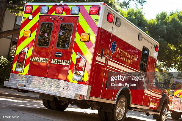 ambulance on the street in an emergency - emergency response stock pictures, royalty-free photos & images