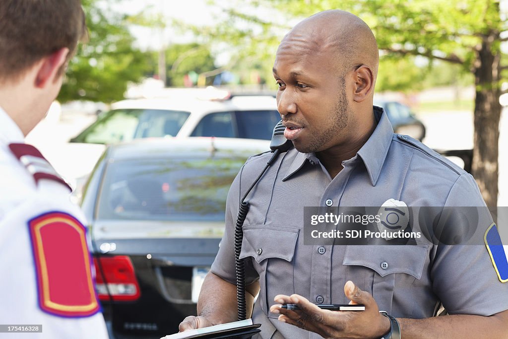 Police officer interogating people at an emergency scene