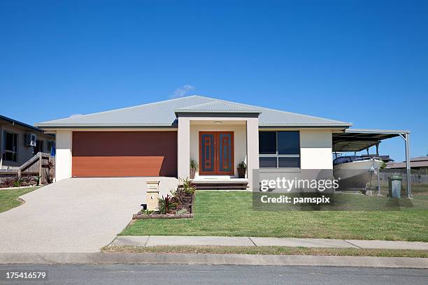 modern home with boat and blue sky copyspace - brick house door stock pictures, royalty-free photos & images