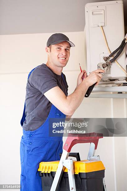 serviceman - air conditioner installation stock pictures, royalty-free photos & images