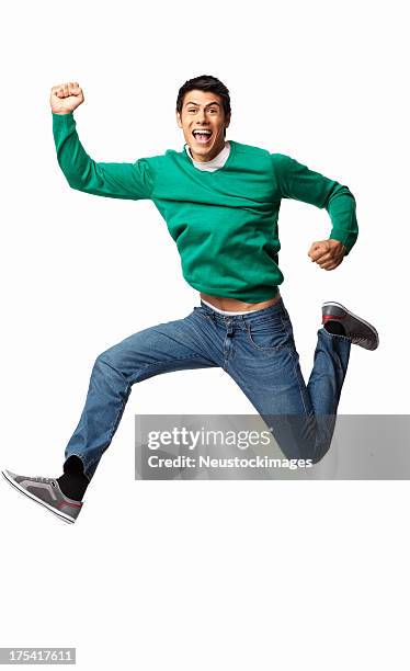 ecstatic young man cheering - isolated - man jumping stock pictures, royalty-free photos & images