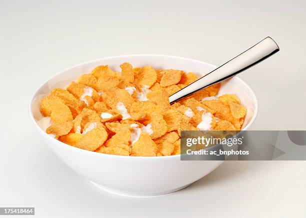 bowl of corn flakes with spoon - schaal stockfoto's en -beelden