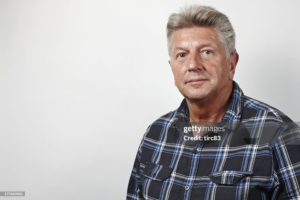 Mature man serious look head and shoulders portrait
