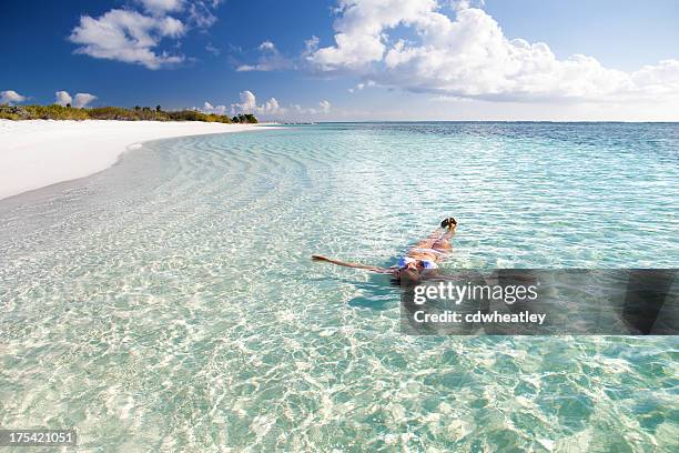 frau entspannt in das kristallklare wasser des karibischen strand - anegada stock-fotos und bilder