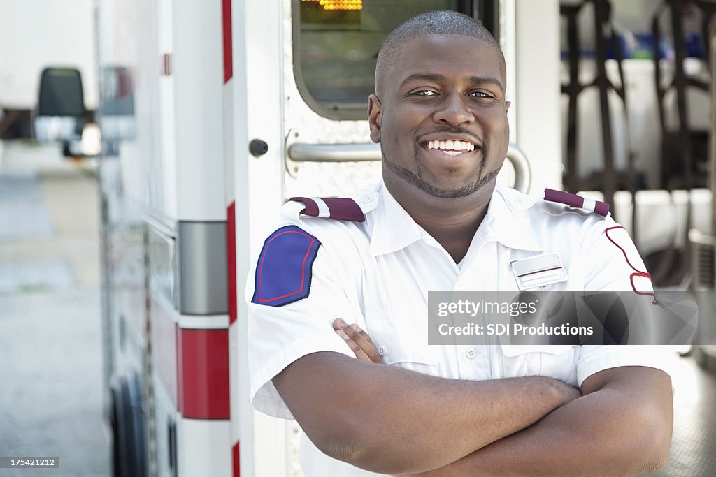 Confident emergency response worker at his ambulance