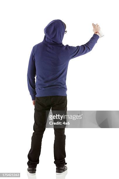 rear view of a man doing graffiti - spray paint isolated stock pictures, royalty-free photos & images