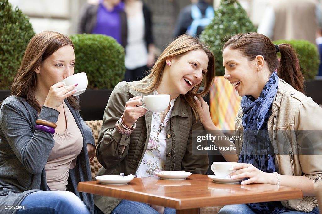 Young Women Having Fun Drinking Coffee Outdoors.