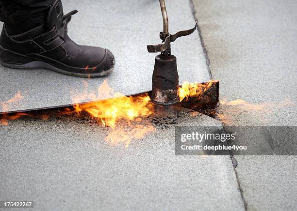 bitumen roofing felt roll for melting by gas heate - waterproofing stock pictures, royalty-free photos & images