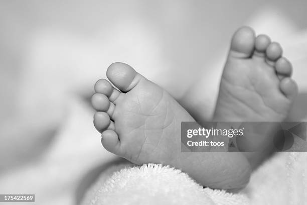 baby feet close-up, monochrome - newborn feet stock pictures, royalty-free photos & images