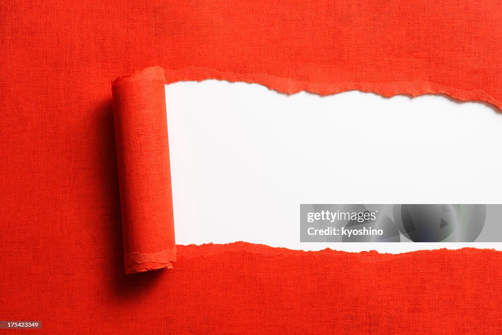Isolated shot of torn red paper on white background