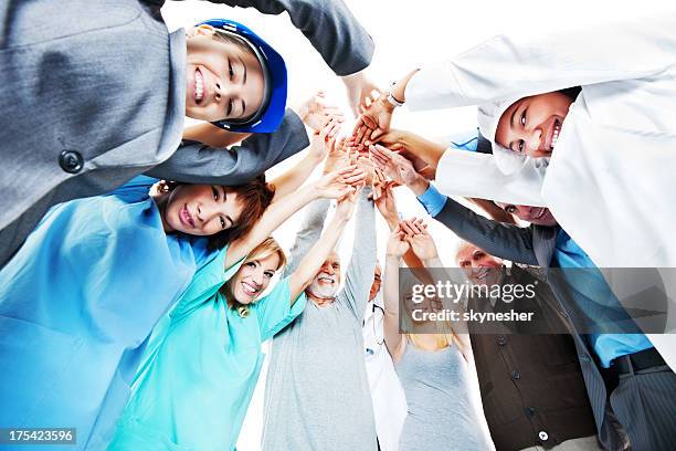 people of various occupations putting their hands together. - various occupations stock pictures, royalty-free photos & images