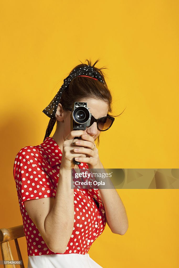 Young retro woman filming