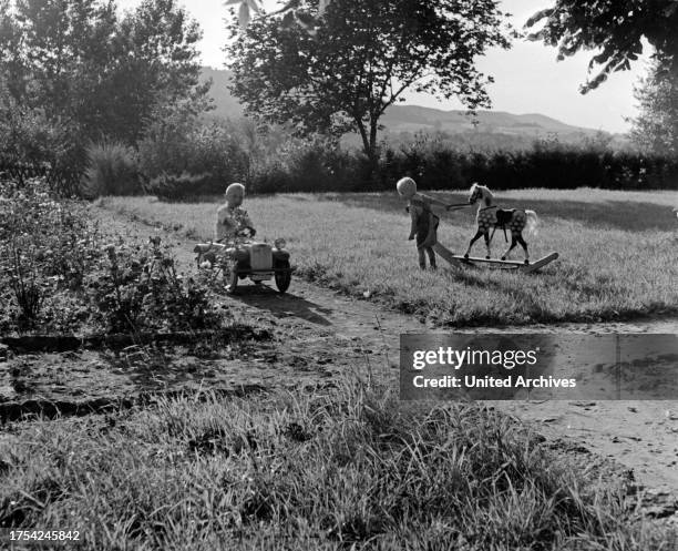 Farmer children from Westphalia playing in the garden, Germany 1930s.