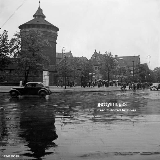 Frauentor gate in the Southeast of the old Nuremberg city wall on a rainy day, Germany 1930s.