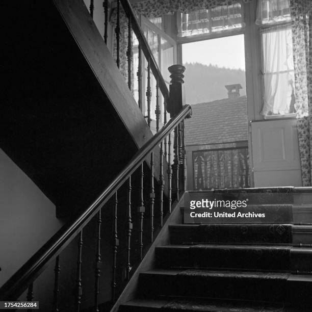 View into an old wooden staircase inside a house at Triberg in Black Forest, Germany 1930s.