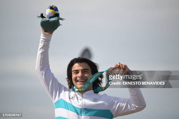 Argentina's Santino Basaldella poses on the podium with his bronze medal after the men's surfing SUP race final of the Pan American Games Santiago...