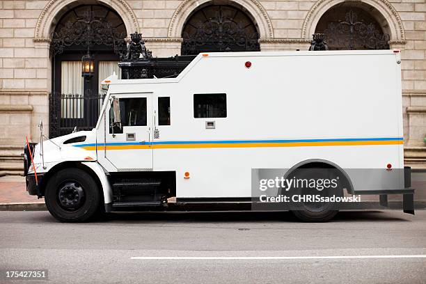 armored truck at bank - armoured stockfoto's en -beelden