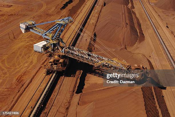 ore reclaimer collecting crushed ore on a minesite. - iron ore stock pictures, royalty-free photos & images