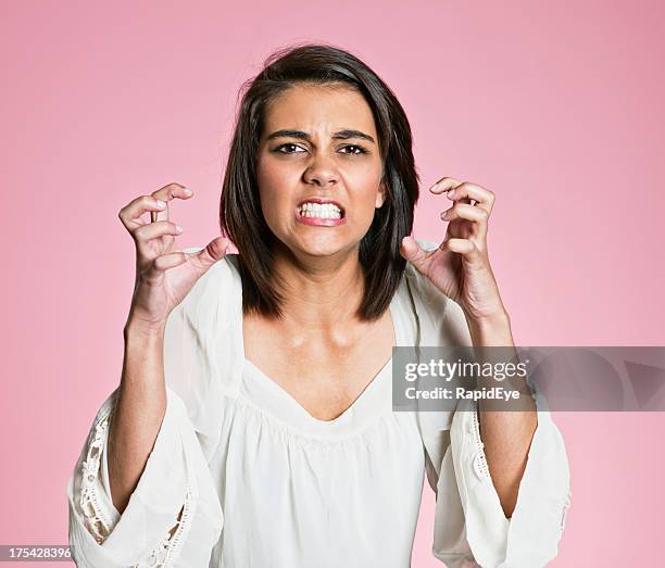 frustrated and furious young woman gestures grimacing - shaking-fist stock pictures, royalty-free photos & images