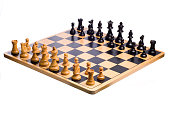 A wooden chessboard set up prior to play