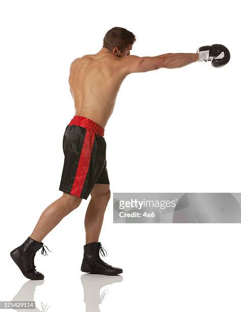 profile of a male boxer in action - boxing young men stock pictures, royalty-free photos & images