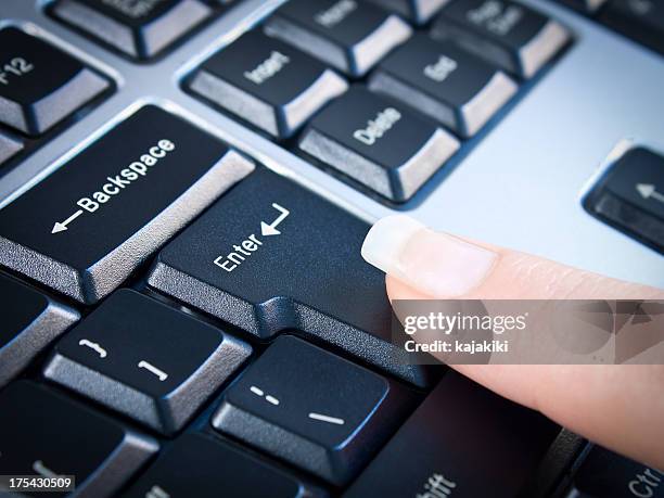 typing on keyboard - enter key stock pictures, royalty-free photos & images