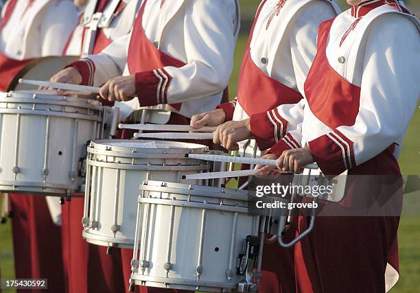 marching band playing drums with red uniform - marching band stock pictures, royalty-free photos & images