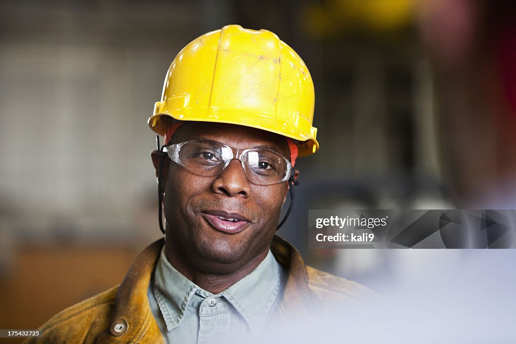 African American worker talking to co-worker