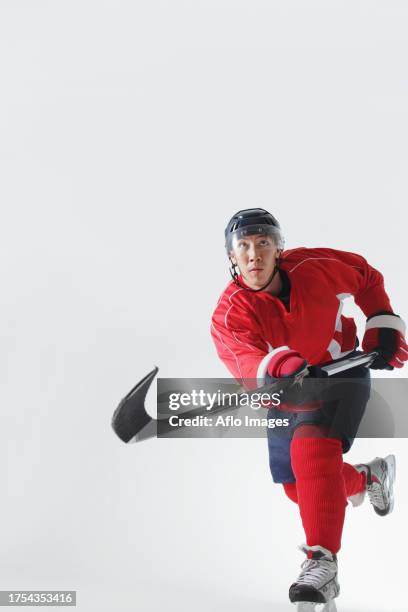 young male ice hockey player - hockey player on white stock pictures, royalty-free photos & images