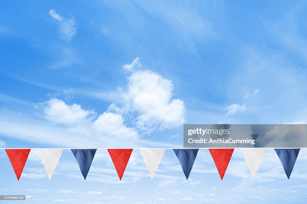 A line of British bunting hanging in the blue sky