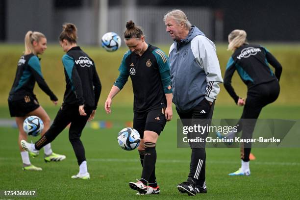 Germany Women's head coach Horst Hrubesch chats with Marina Hegering during a Germany Women's training session at DFB Campus on October 24, 2023 in...