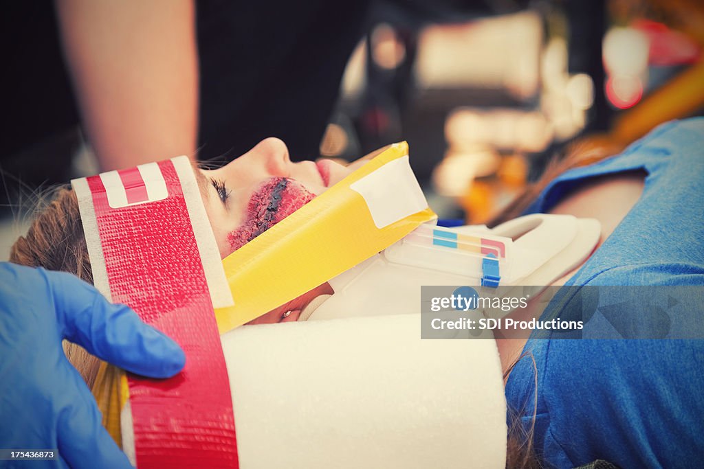 Closeup of injured young woman on a stretcher