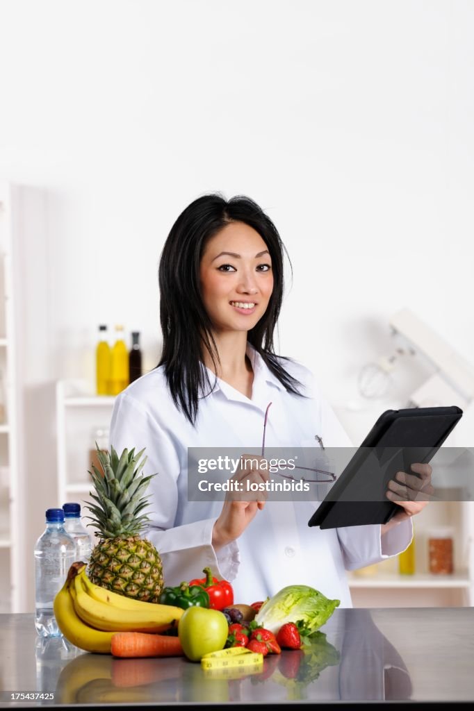 Oriental Healthcare Professional Using Digital Tablet