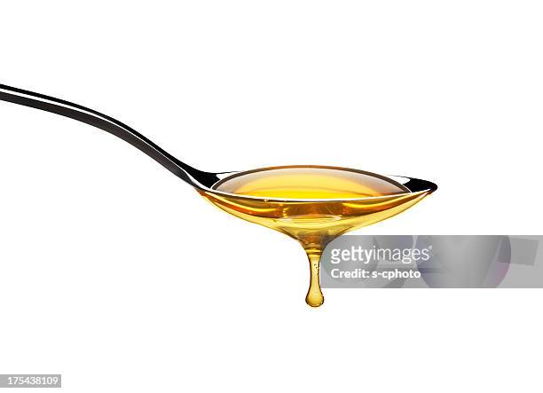 honey dripping from spoon - syrup stock pictures, royalty-free photos & images