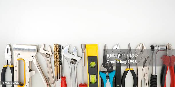 work tools lined up on a white background - construction equipment stockfoto's en -beelden