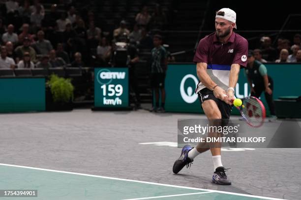Tommy Paul plays a backhand return to France's Richard Gasquet during their men's singles match on day one of the Paris ATP Masters 1000 tennis...