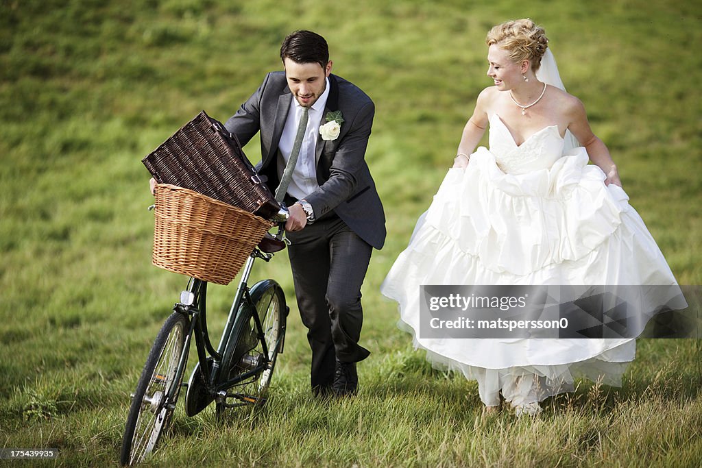 Newlyweds walking through the countryside