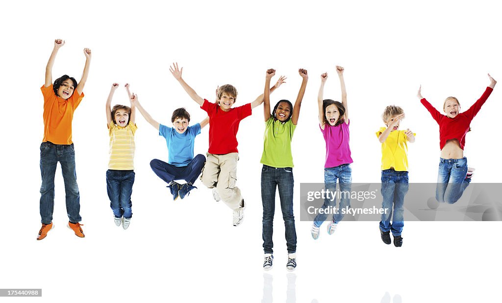 Cheerful kids jumping with arms up.