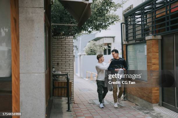 asian chinese gay couple tourist exploring tainan city street - tainan stock pictures, royalty-free photos & images
