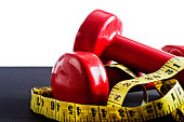 Fitness not fatness: red weights with tape measure