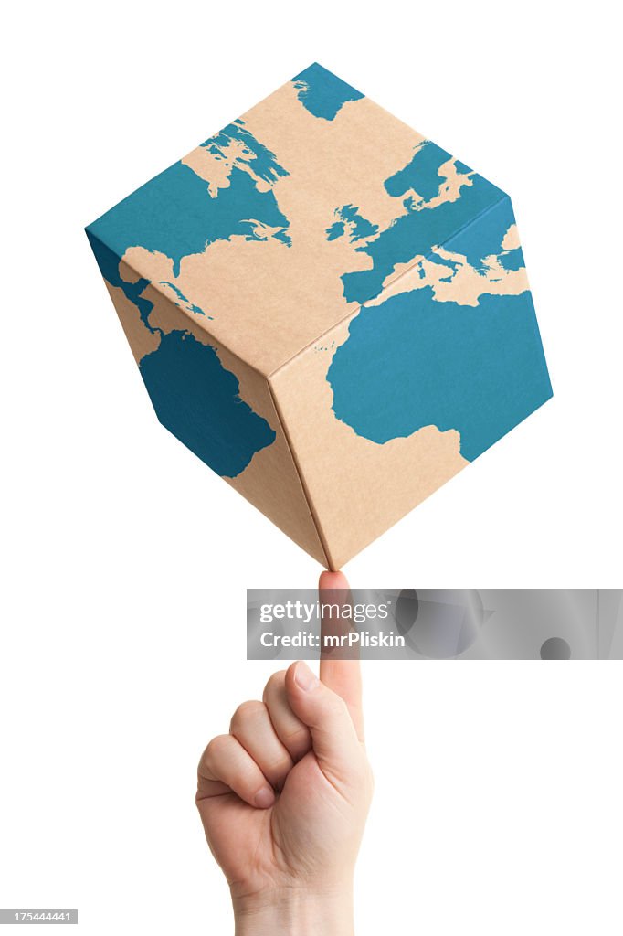 Worldwide parcel delivery cardboard box and world map