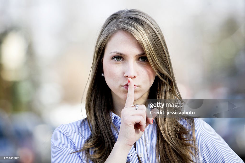 Woman with Finger on Lips