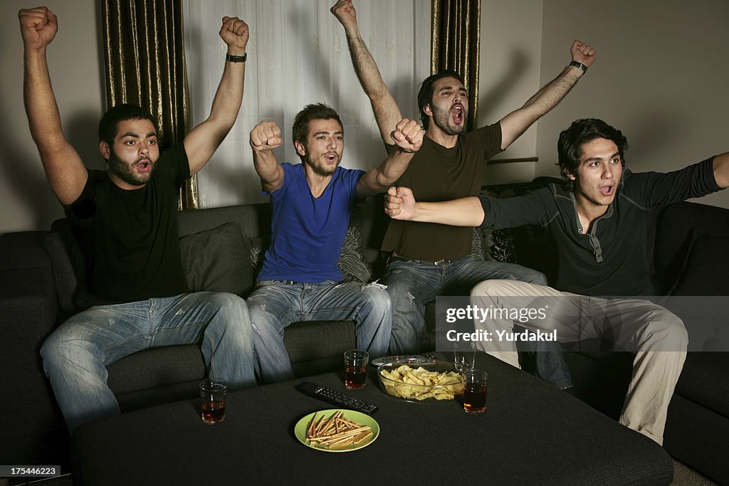 Young men watching sports competition