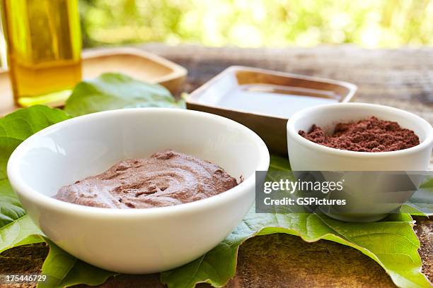 spa still life with mud mask powder and massage oil - mud therapy stock pictures, royalty-free photos & images