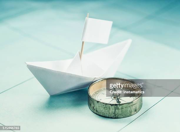 paper boat and compass - toothpick stock pictures, royalty-free photos & images