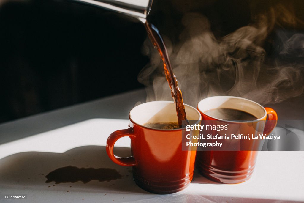 Coffee Pouring in Two Mugs