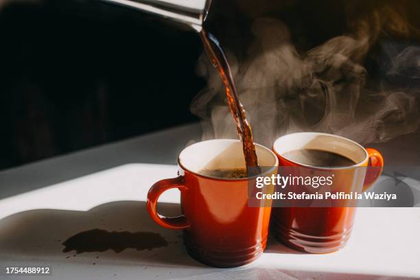coffee pouring in two mugs - coffee bildbanksfoton och bilder